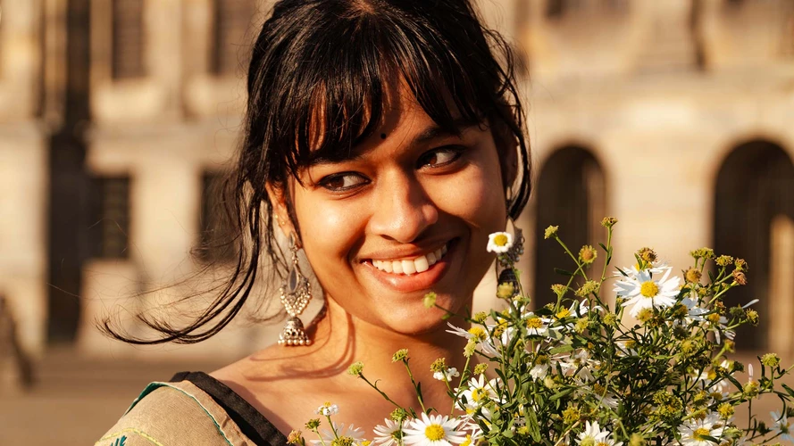 indian model with traditional scarf dancing on dam square by sunrise