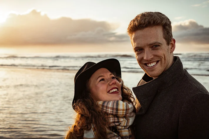 dutch couple enjoying the sunset on the Bergen Aan Zee beach during their couple photoshoot