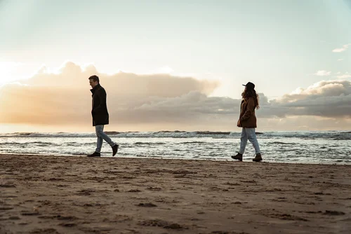 life partners taking a relaxing walk near the shoreline of Bergen Aan Zee