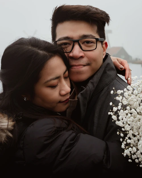 girlfriend hugging her partner with her eyes closed at a prewedding portrait photoshoot