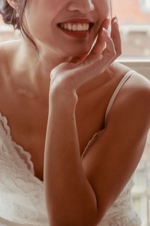 bride in white dress posing during preparation for her wedding