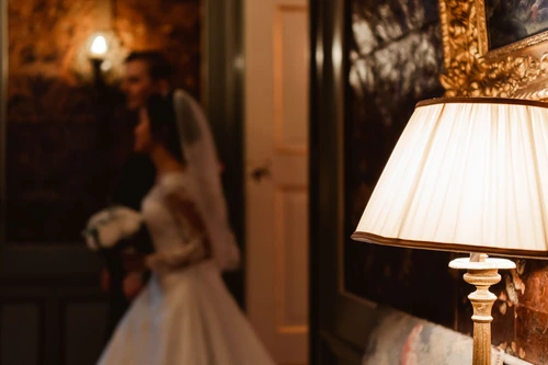 bride and groom walking the corridors of Slot Zeist while holding hands