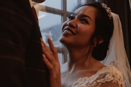 wife smiling at her husband near the window light