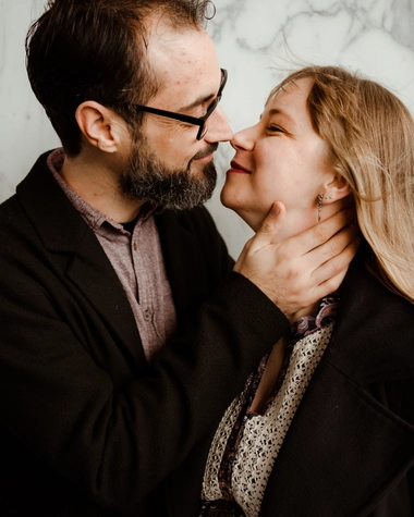 Newlywed couple kiss in front of Almere City Hall during their wedding, captured by DiscussTomorrow