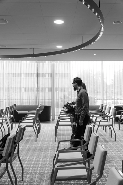 A beautiful black and white photo capturing a couple's special moment as they walk down the aisle in their small partnership registration at gemeente Almere– taken by DiscussTomorrow weddings.