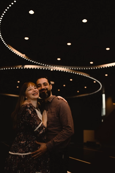 A beautiful composed portrait taken after the partnership registration ceremony at gemeente Almere. The room’s clutter blackground is darkening out while the couple’s best features are captured thanks to the use of flash – by DiscussTomorrow photography.